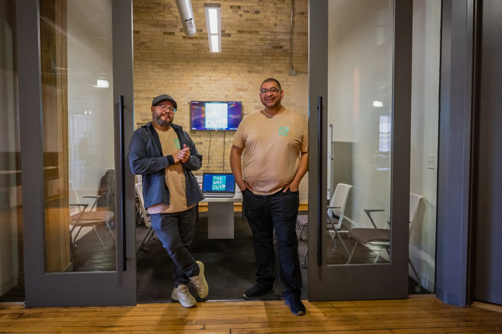 two men standing in a doorway